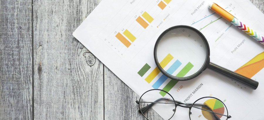 Magnifying glass on top of a report